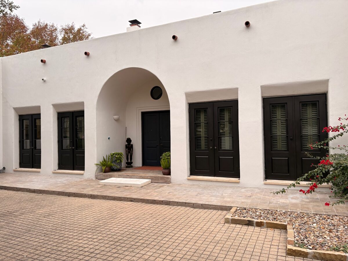 Double Iron Door with Transom on White Stucco